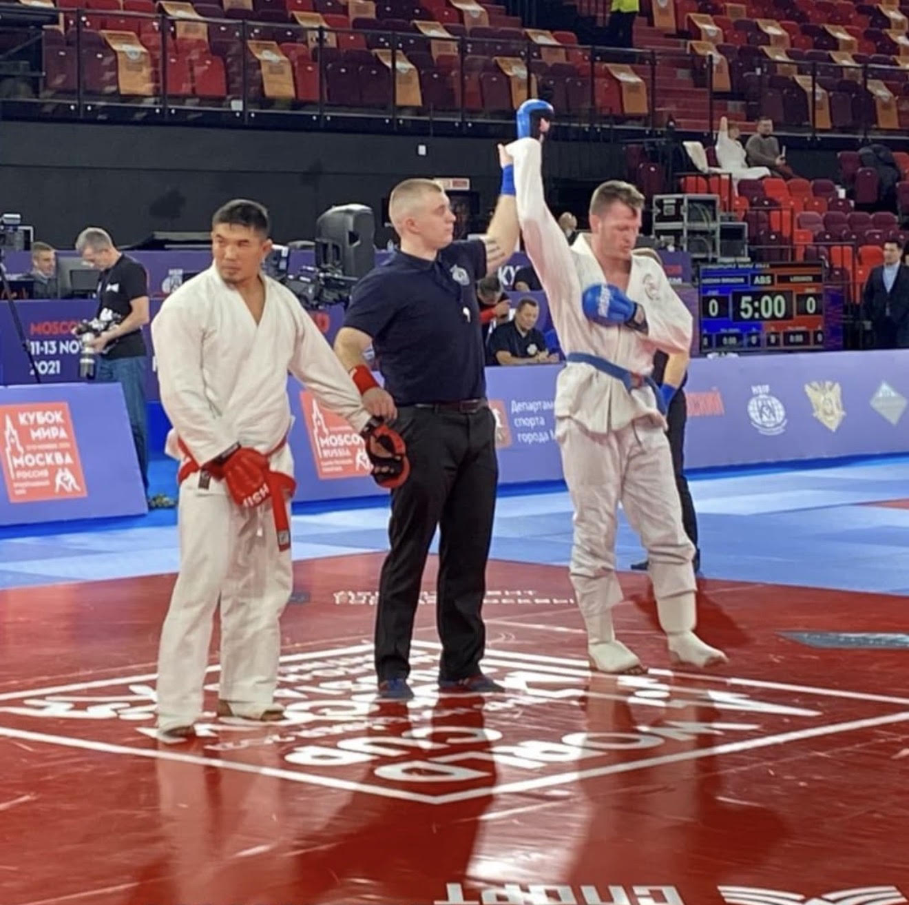 International Sambo competition medal winners celebrating on the podium